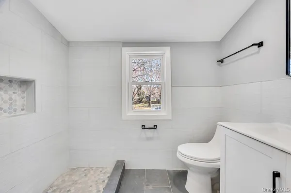 a white toilet sitting next to a bathroom sink