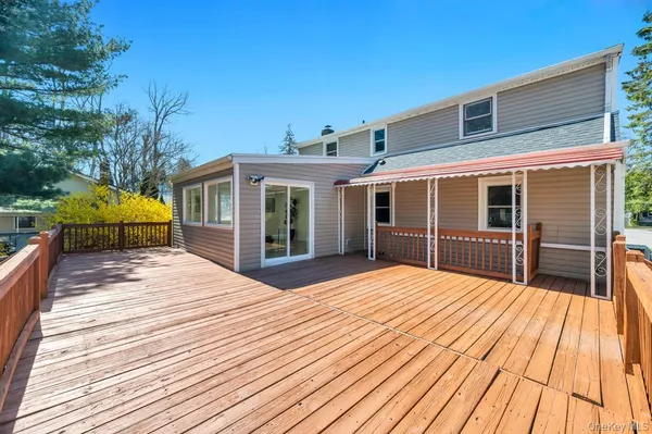 a view of a house with barbeque oven and wooden floor
