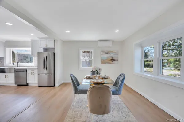a dining room with furniture and a window