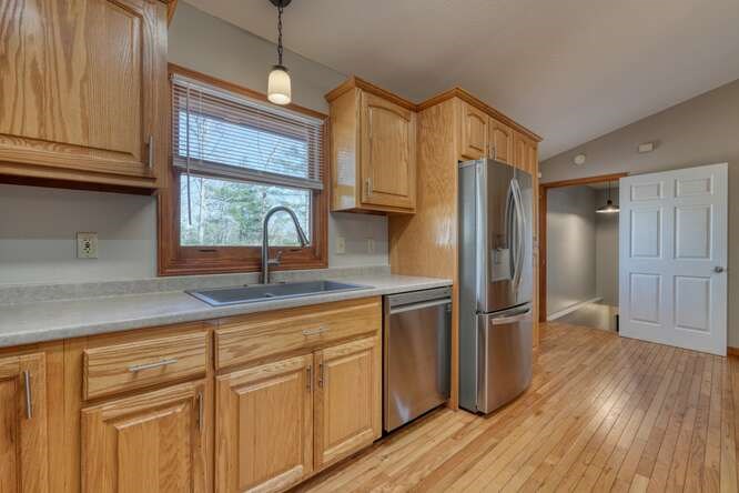 1995 River Hill Road Murphy, NC 28906 - Photo 17 of 68 a kitchen with stainless steel appliances granite countertop a refrigerator a sink and wooden cabinets
