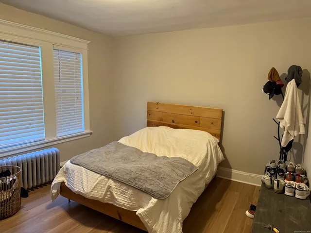 a bedroom with a bed and windows