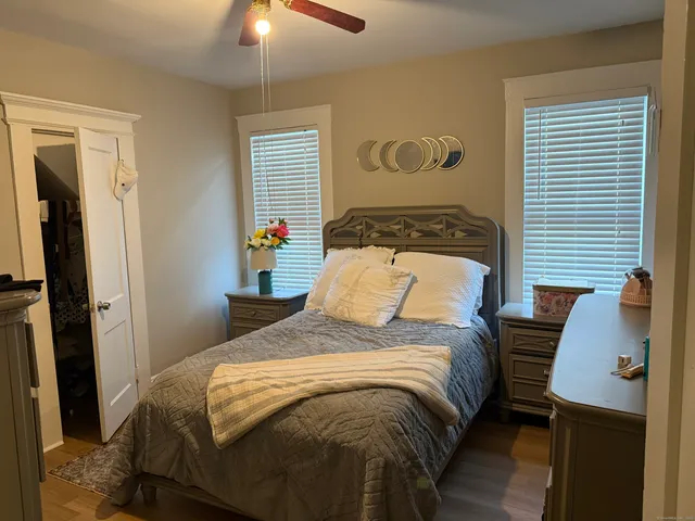 a bedroom with a bed and a chandelier