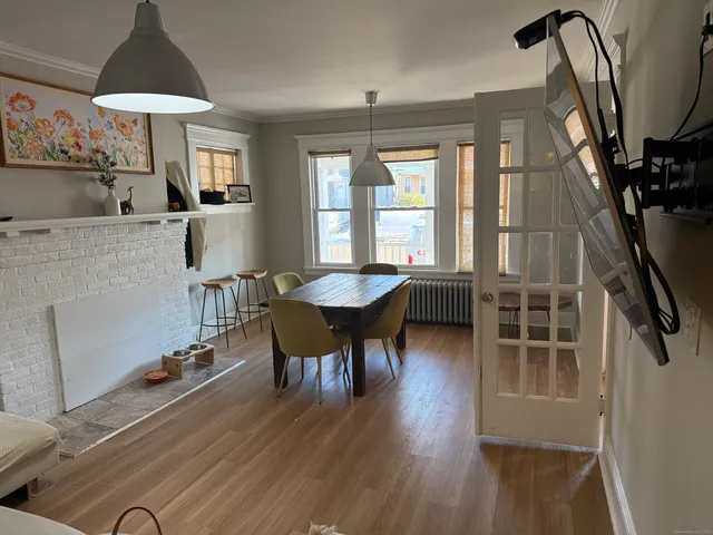 a dining room with furniture and wooden floor