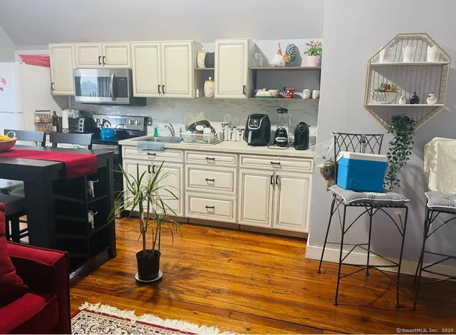 a kitchen with stainless steel appliances granite countertop a stove and cabinets
