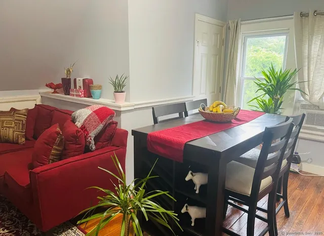 a dining room with furniture and a potted plant