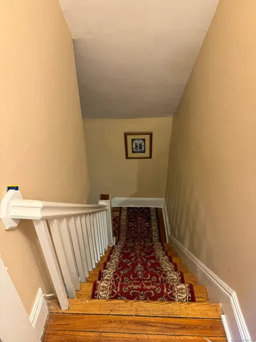 a view of a room with wooden floor