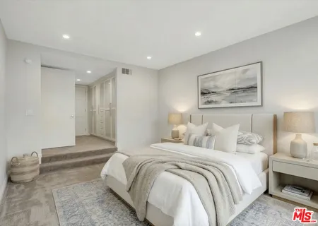 a spacious bedroom with a bed and a couch