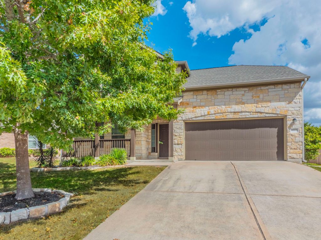 a front view of a house with garden