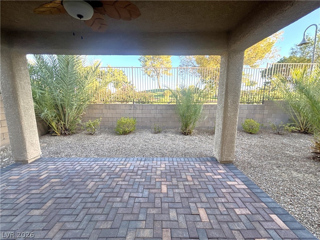 121 Elm Reed Avenue Las Vegas, NV 89113 - Photo 28 of 30 A private paved patio transitions to a gravel landscape with mature plantings and a view.