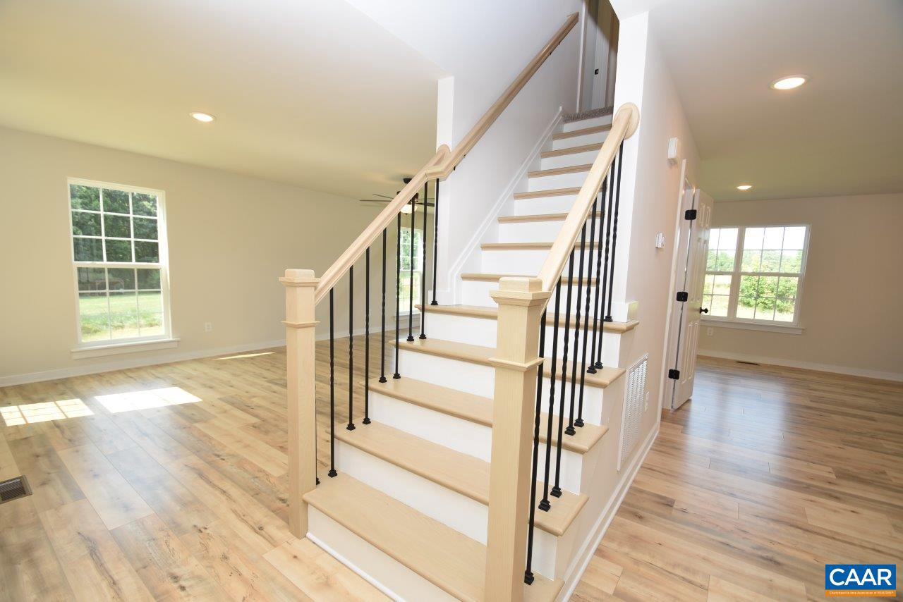 11675 West Jack Jouett Road Zion Crossroads, VA 22942 - Photo 11 of 33 a view of a hallway with wooden floor and windows