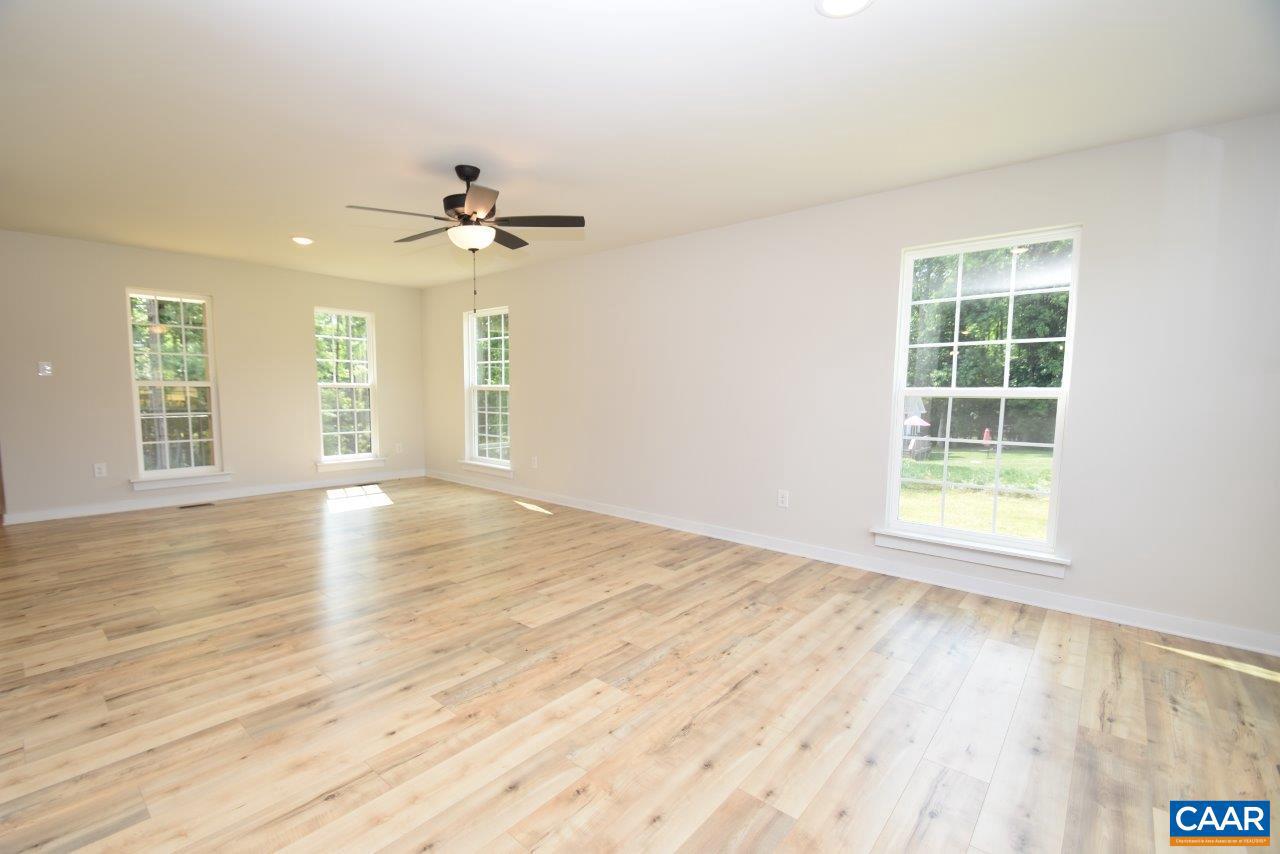 11675 West Jack Jouett Road Zion Crossroads, VA 22942 - Photo 7 of 33 wooden floor in an empty room with a window