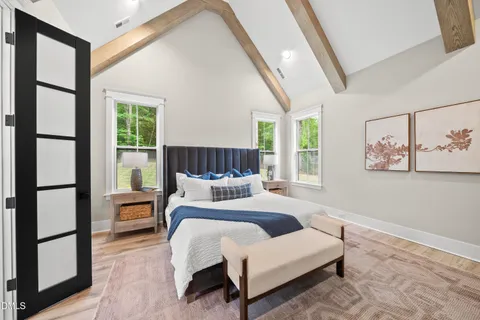 a bedroom with furniture and a large window