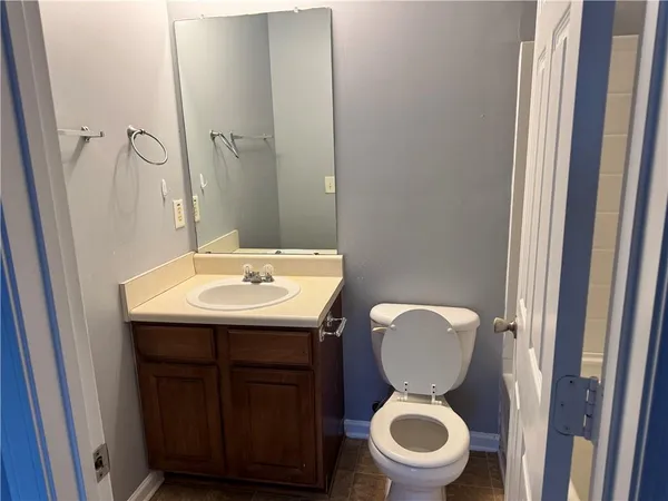 a bathroom with a toilet a sink and a mirror