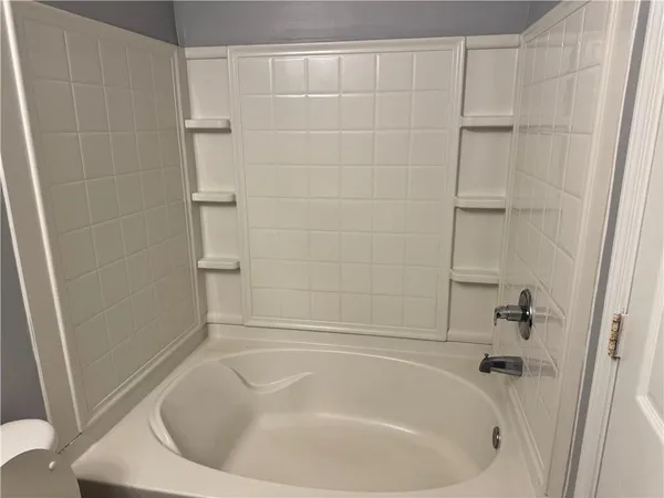 a white bath tub sitting in a bathroom
