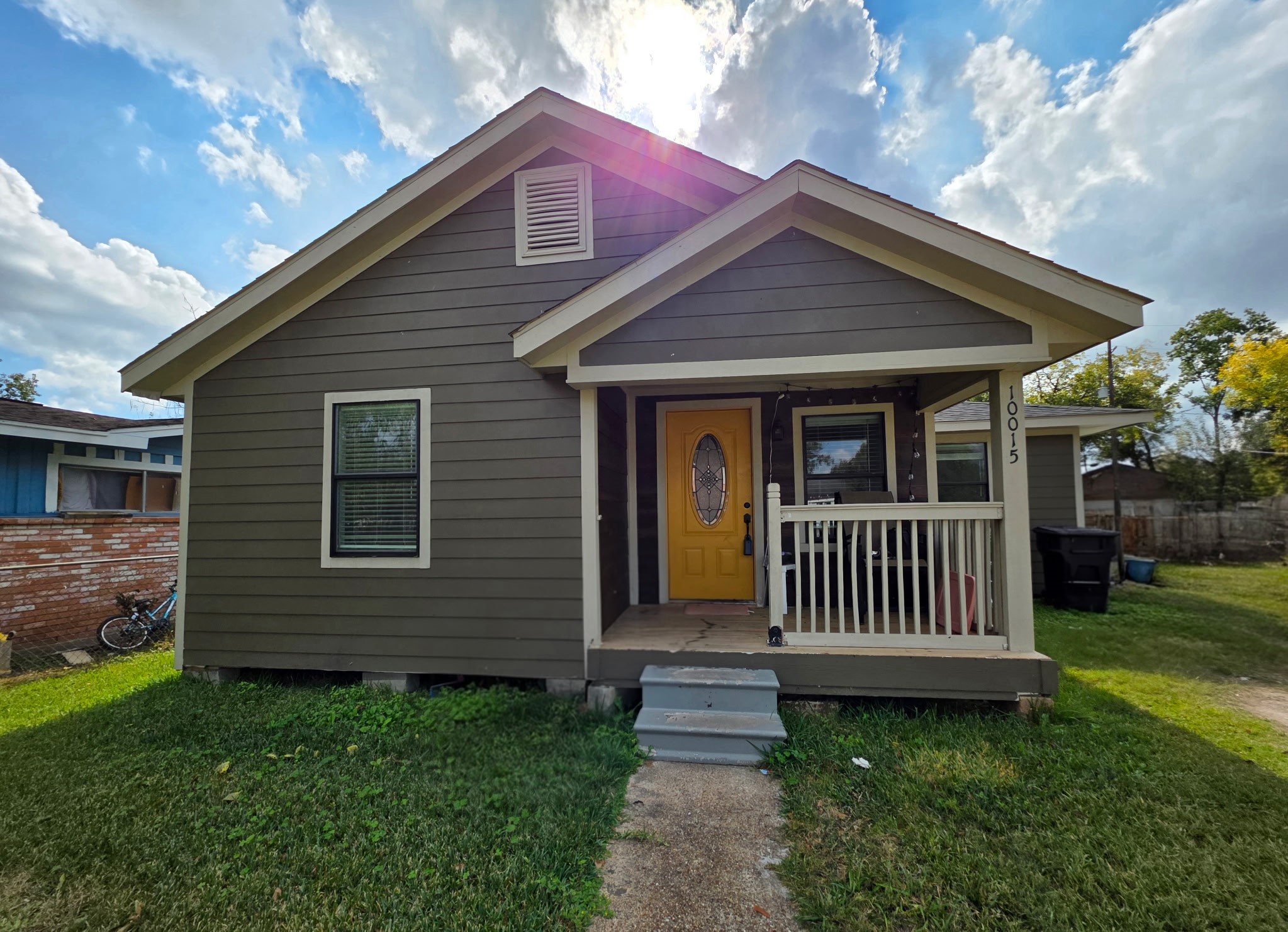 a front view of a house with a garden