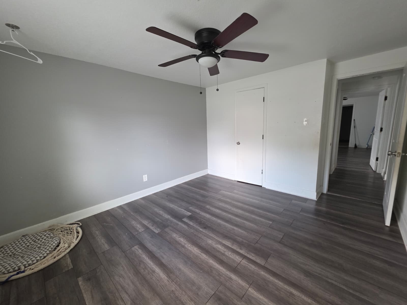 10015 Porto Rico Road Houston, TX 77041 - Photo 11 of 20 an empty room with wooden floor and a ceiling fan