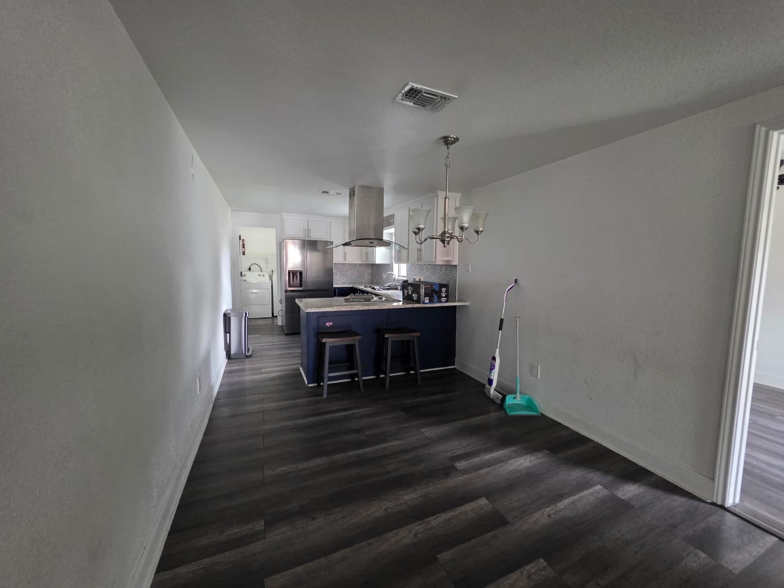 10015 Porto Rico Road Houston, TX 77041 - Photo 4 of 20 a living room with kitchen island furniture and a chandelier