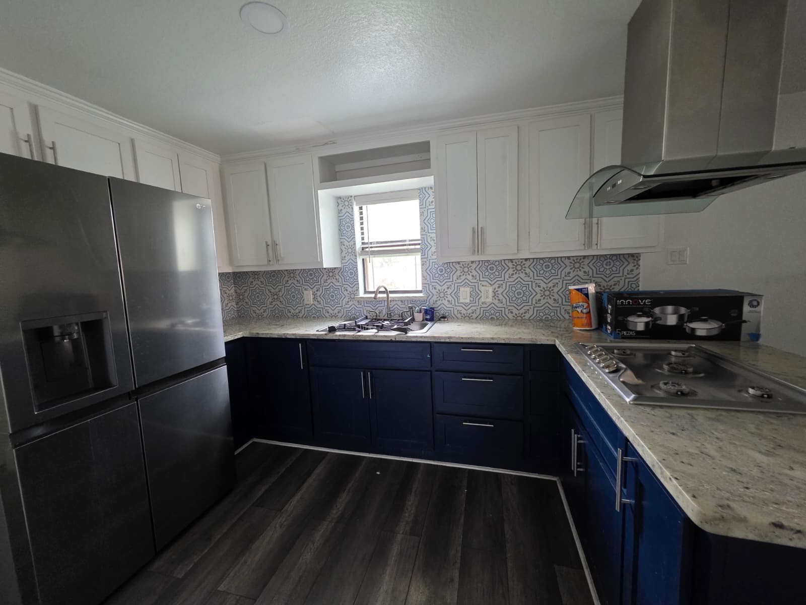 10015 Porto Rico Road Houston, TX 77041 - Photo 6 of 20 a kitchen with granite countertop stainless steel appliances a refrigerator a sink and wooden cabinets