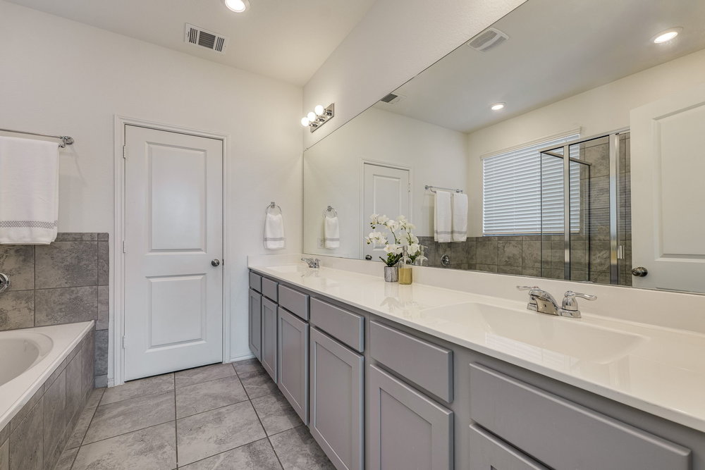 1107 Winifred Drive Austin, TX 78748 - Photo 21 of 40 Dual vanities, soaking tub, and walk-in shower.