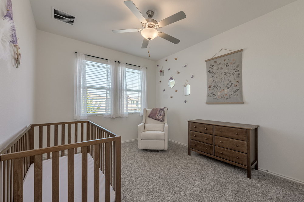 1107 Winifred Drive Austin, TX 78748 - Photo 26 of 40 Peaceful secondary bedroom with soft natural light and plush carpet.