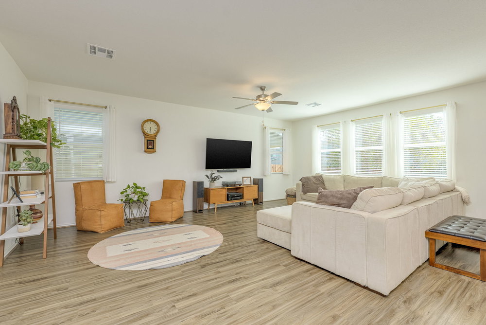 1107 Winifred Drive Austin, TX 78748 - Photo 7 of 40 Natural light fills the living room, creating a warm and spacious feel.