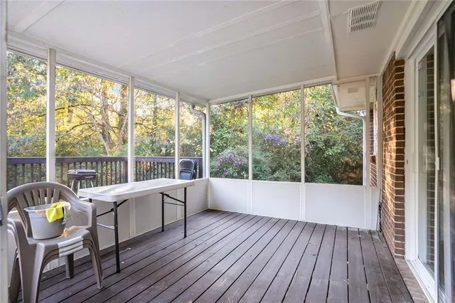 a view of room with wooden floor and furniture