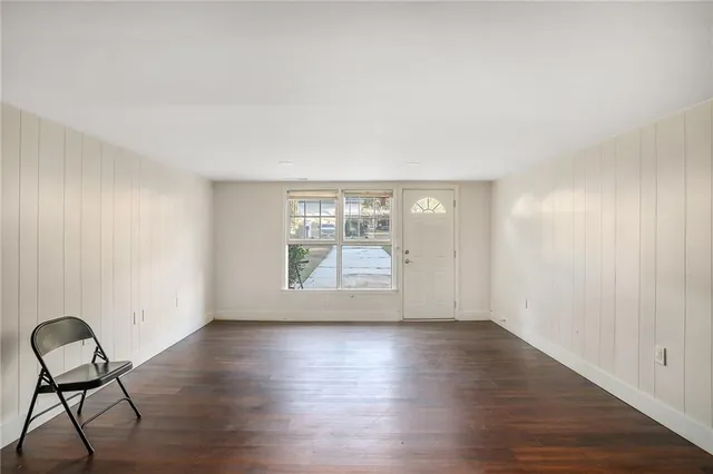 a view of room with window and wooden floor
