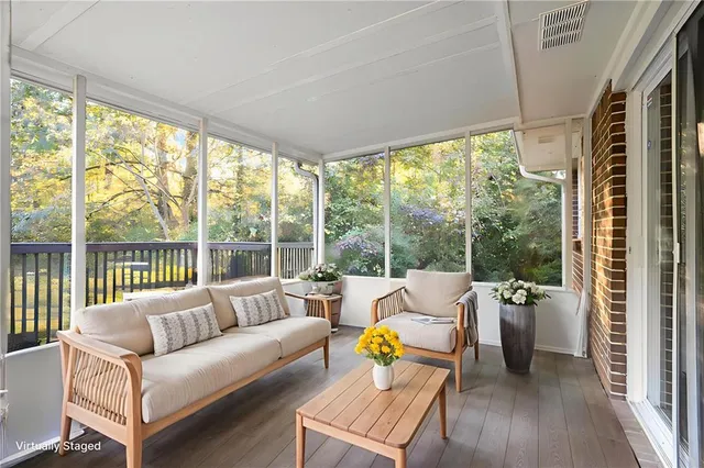 a living room with furniture and floor to ceiling windows