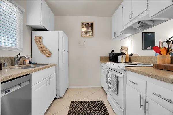 a view of a livingroom with workspace and a couch