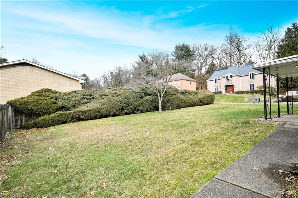 653 Filmore Road Pittsburgh, PA 15221 - Photo 22 of 23 a backyard of a house with large trees and outdoor seating