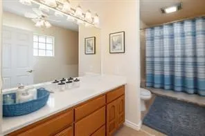 a kitchen with a refrigerator and a stove top oven