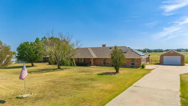 a aerial view of a house with swimming pool and sitting area