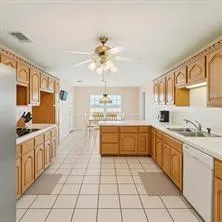 a kitchen with a sink a stove cabinets and a counter top space