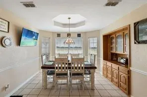 a spacious bedroom with a bed and a chandelier