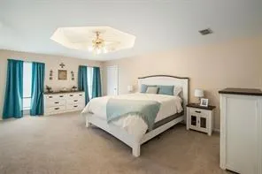 a bedroom with a bed dresser and a window