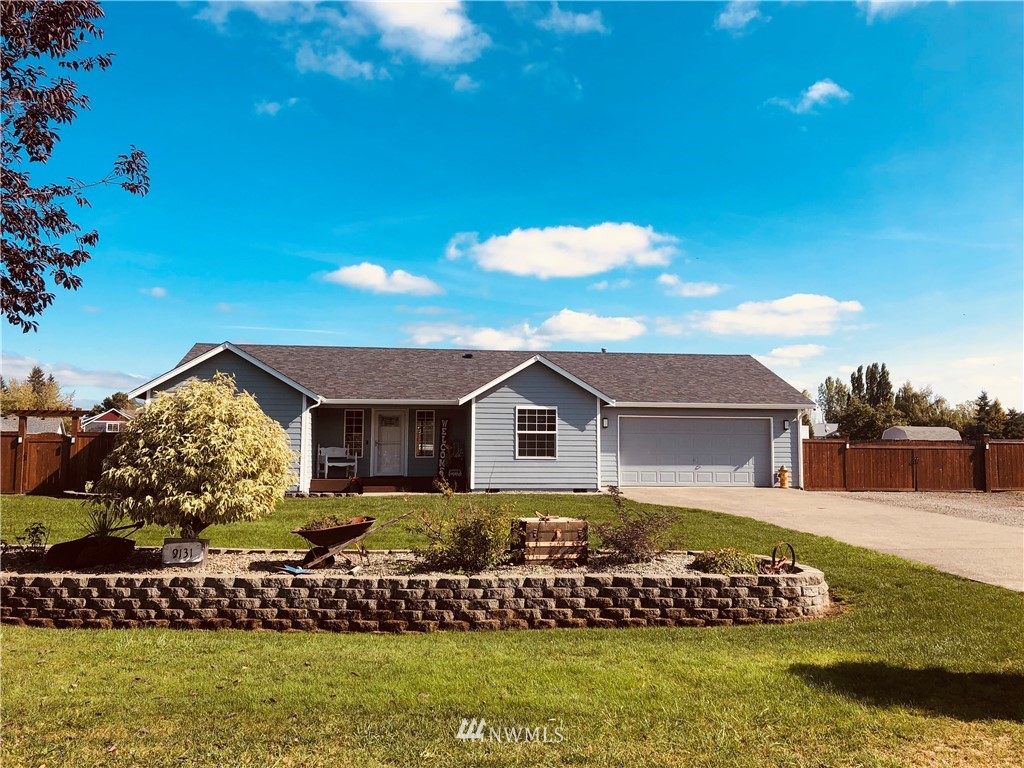9131 Applegate Loop Southwest Rochester, WA 98579 - Photo 2 of 32 a front view of a house with a garden