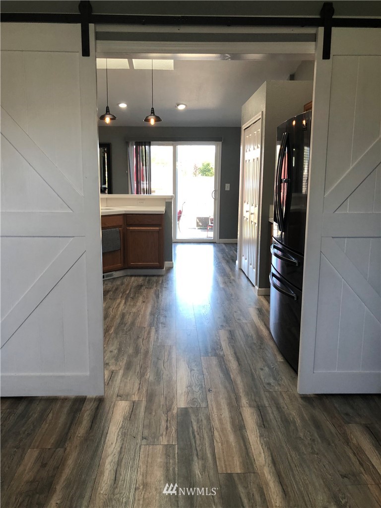 9131 Applegate Loop Southwest Rochester, WA 98579 - Photo 15 of 32 a large kitchen with granite countertop a refrigerator and a sink