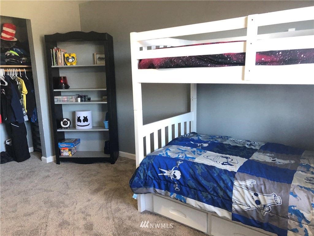 9131 Applegate Loop Southwest Rochester, WA 98579 - Photo 22 of 32 a bedroom with a bed and a window