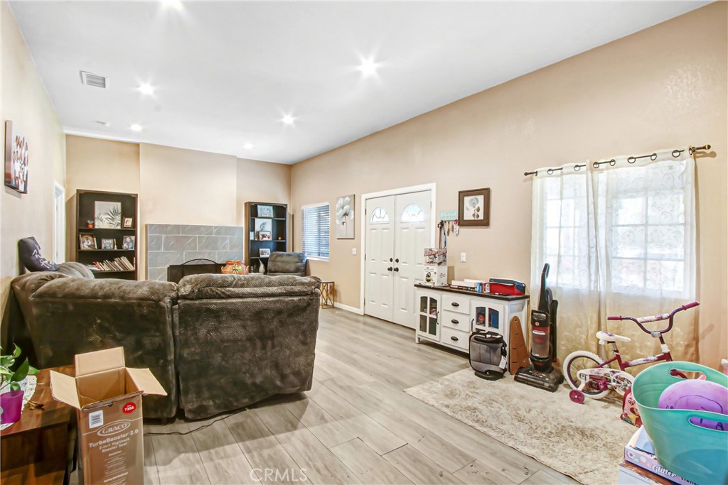 2249 Serrano Road North San Bernardino, CA 92405 - Photo 11 of 26 a living room with furniture and a flat screen tv