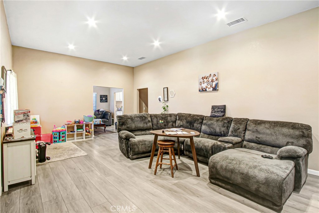 2249 Serrano Road North San Bernardino, CA 92405 - Photo 13 of 26 a living room with furniture and a wooden floor