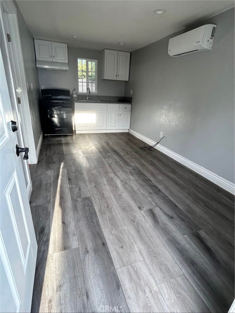 2249 Serrano Road North San Bernardino, CA 92405 - Photo 26 of 26 a view of empty room with wooden floor and fireplace
