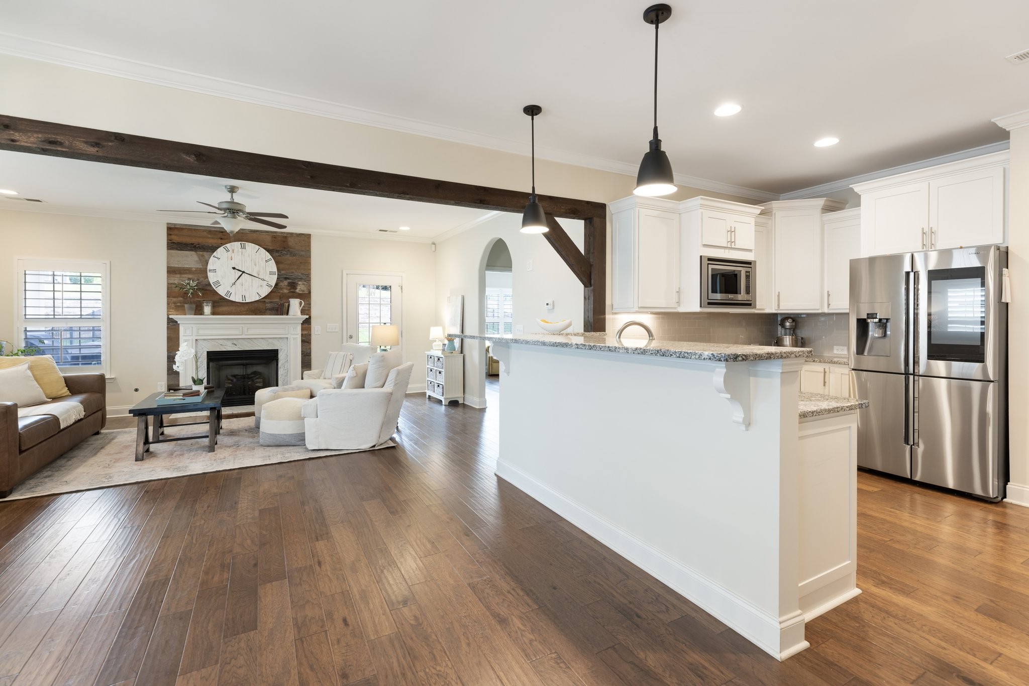 1044 Scouting Drive Franklin, TN 37064 - Photo 32 of 87 a kitchen with kitchen island a island a stove a refrigerator a dining table and chairs with wooden floor