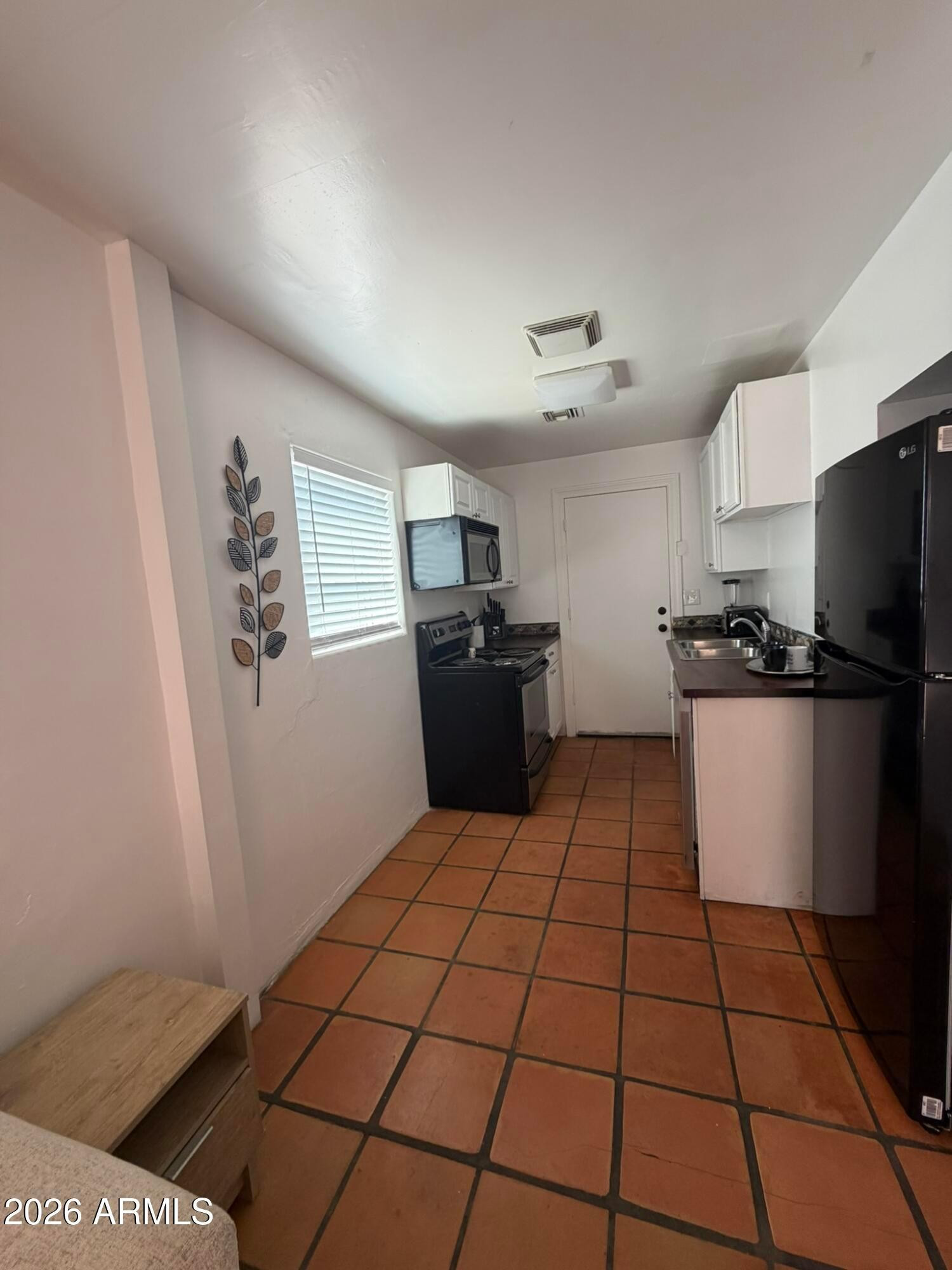 712 West Taylor Street, Unit 2 Phoenix, AZ 85007 - Photo 3 of 6 a kitchen with a refrigerator and a stove top oven