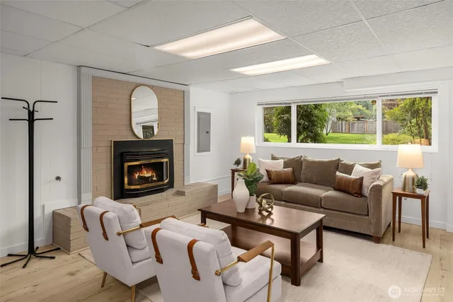 a living room with furniture fireplace and window
