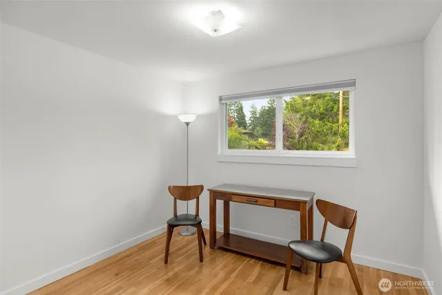a view of a workspace with furniture and a window