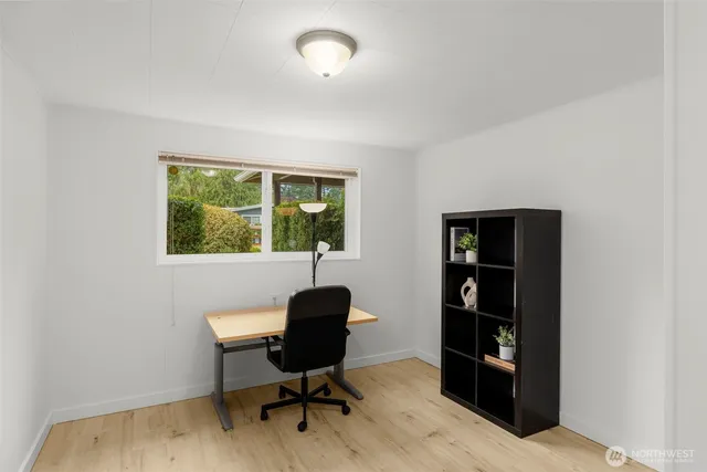 a workspace with furniture hardwood and a window