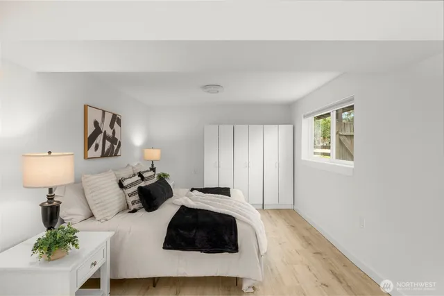 a bedroom with a bed window and wall painting