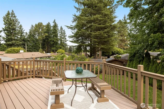a view of a balcony with wooden floor and outdoor seating