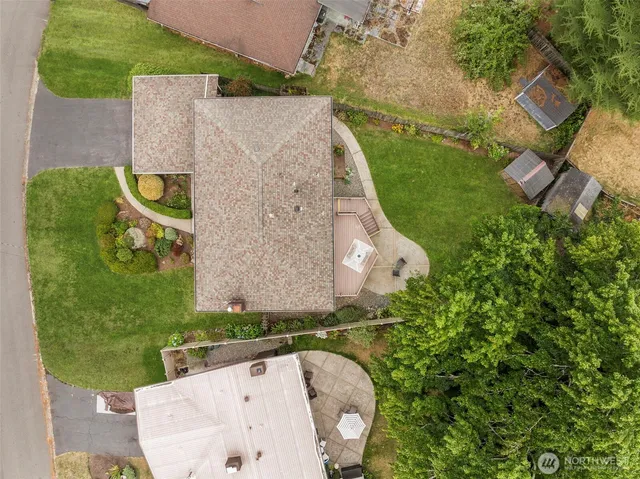an aerial view of a house with a garden and a yard