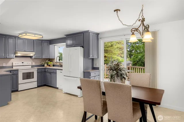 a kitchen with kitchen island a counter top space a sink stainless steel appliances and cabinets